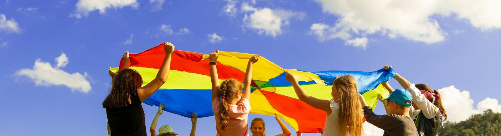 group of women standing on green grass field during daytime
